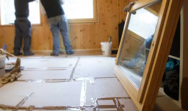 Home building project in progress, with exposed walls and a new window about to be installed.
